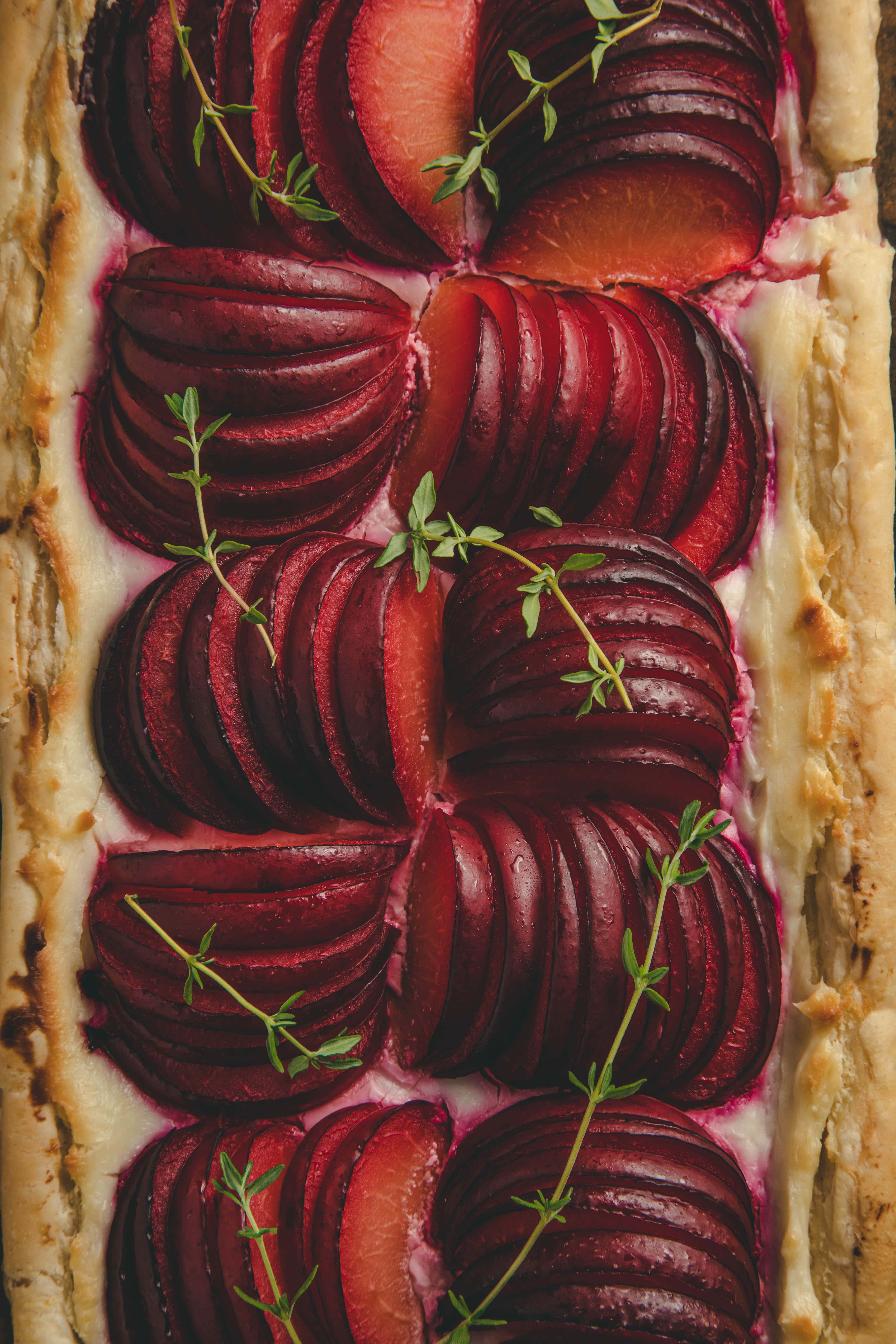 Puff Pastry Plum Tart close up garnished with thyme sprigs