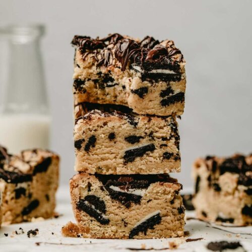 Stack of oreo blondies, with top piece having a large bite taken out.